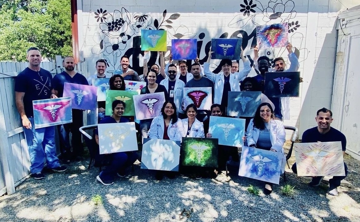Residents performing a group painting activitiy