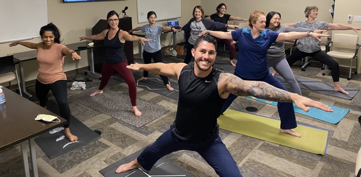Residents and faculty participating in a yoga class