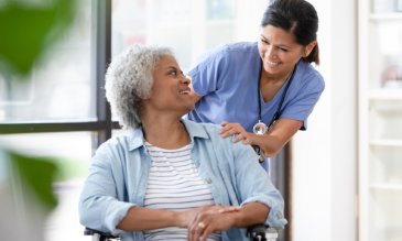 Nurse pushing a patient in a wheelchair